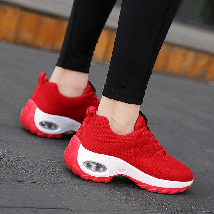 Red breathable women's sneakers SF0775 with mesh upper and EVA insole, feature stylish and flexible design for active wear.